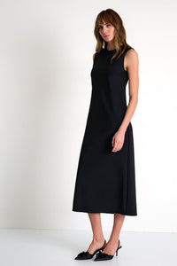 Woman wearing a black sleeveless dress on a white background