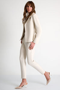 Woman wearing a beige suit on a white background