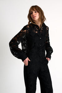 Woman wearing a black lace outfit on a white background