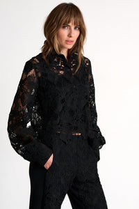 Woman wearing a black lace outfit on a white background