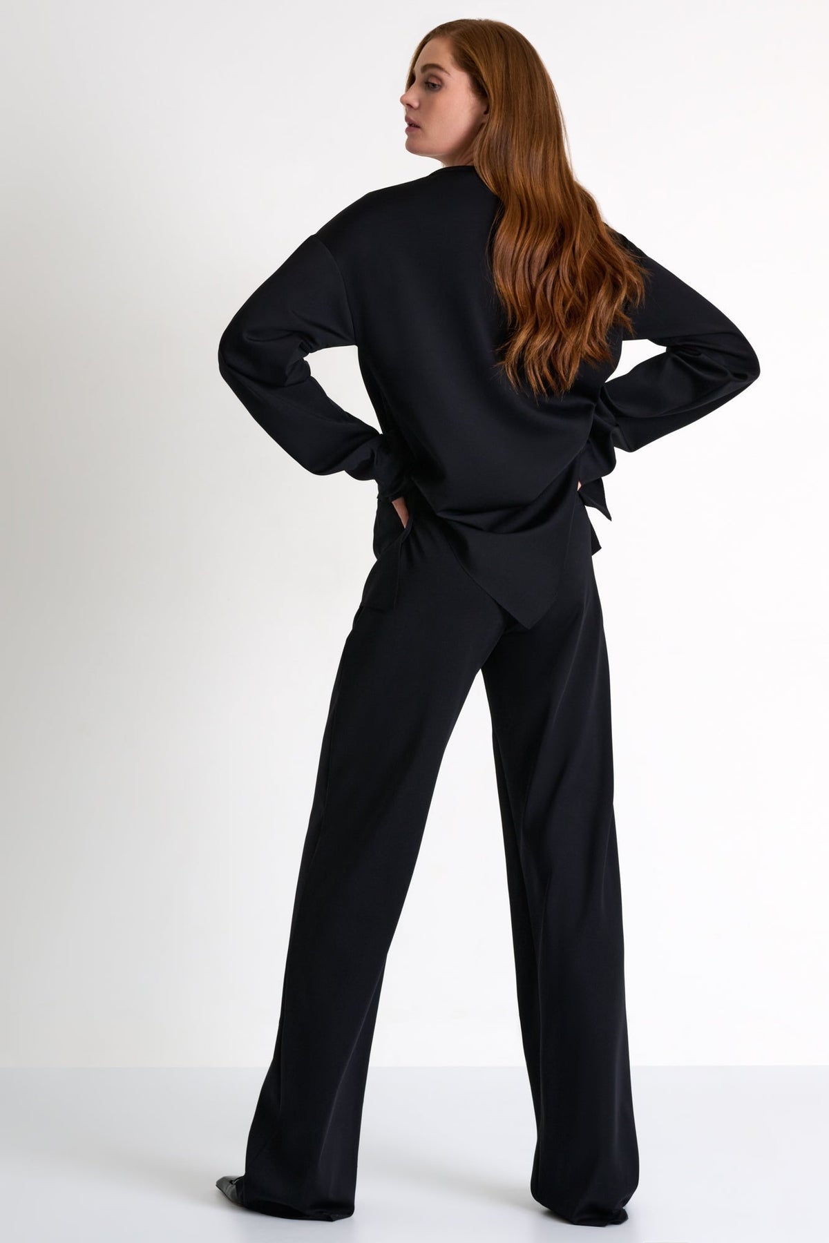 Woman wearing a black outfit on a white background