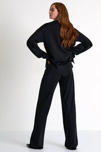 Woman wearing a black outfit on a white background