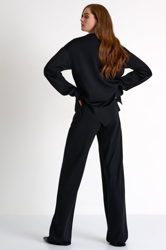 Woman wearing a black outfit on a white background