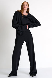 Woman wearing a black outfit on a white background