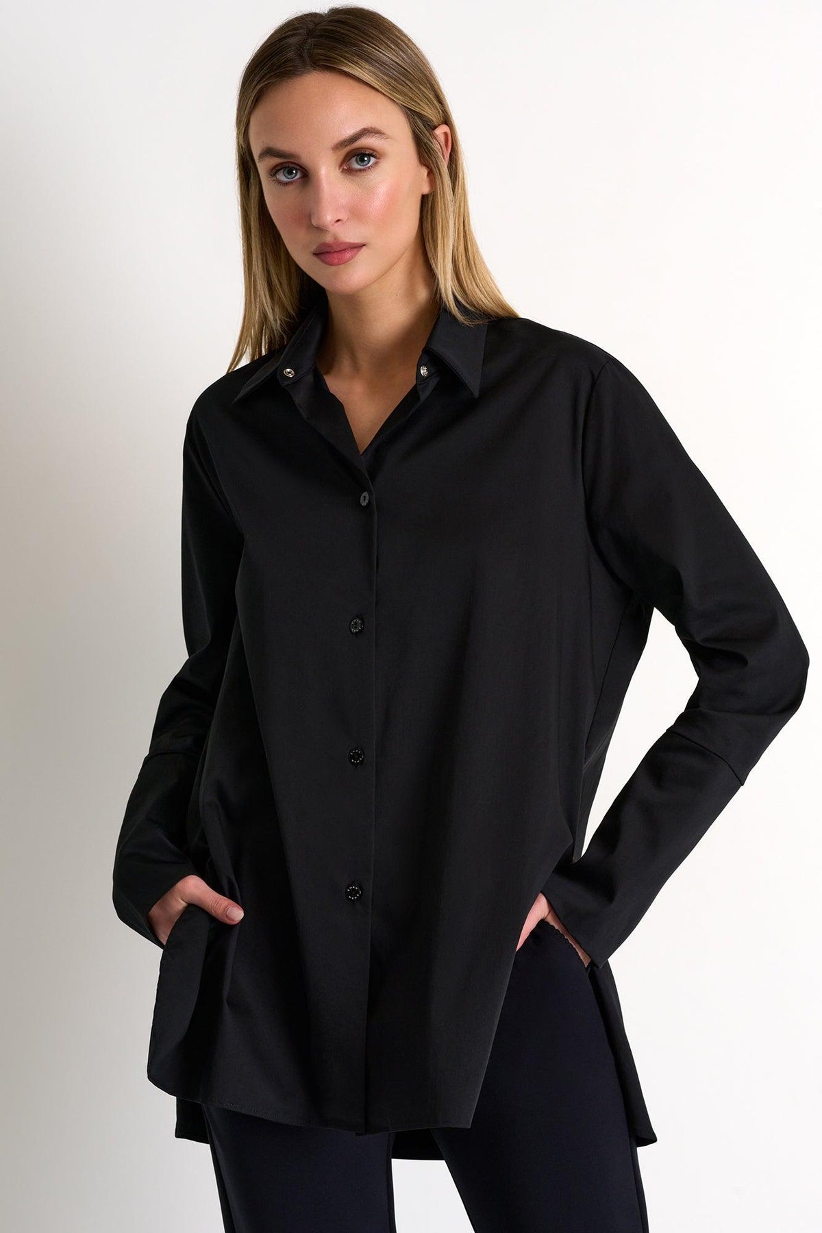 Woman wearing a black shirt against a plain background
