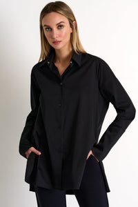 Woman wearing a black shirt against a plain background