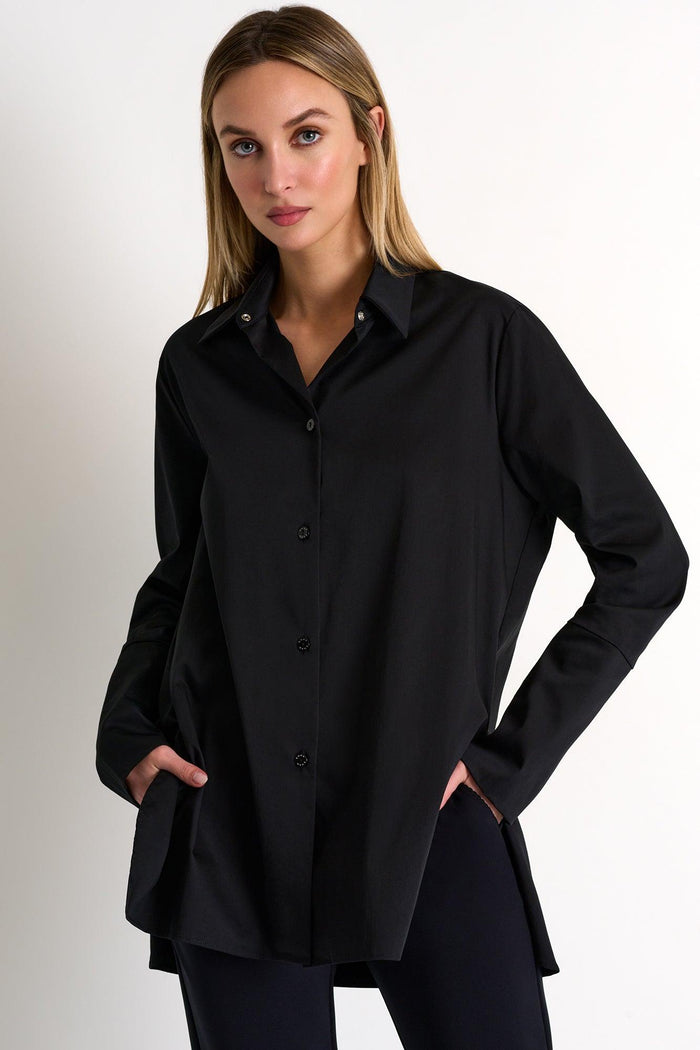 Woman wearing a black shirt against a plain background