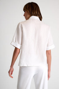 Person wearing a white outfit on a plain background